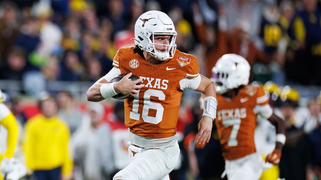 Texas Longhorns quarterback Arch Manning rushes with the ball for a touchdown against the Michigan Wolverines
