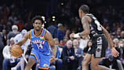 Apr 10, 2024; Oklahoma City, Oklahoma, USA; Oklahoma City Thunder forward Adam Flagler (14) drives to the basket against San Antonio Spurs guard Jamaree Bouyea (15) during the second half at Paycom Center. Mandatory Credit: Alonzo Adams-Imagn Images