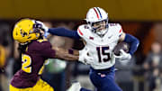 Nov 28, 2025; Tempe, Arizona, USA; Arizona Wildcats wide receiver Luke Wysong (15) stiff arms  Arizona State Sun Devils cornerback Joseph Smith (22) in the first half during the 99th Territorial Cup at Mountain America Stadium. Mandatory Credit: Mark J. Rebilas-Imagn Images
