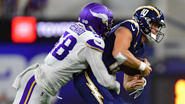 Oct 23, 2025; Inglewood, California, USA; Minnesota Vikings linebacker Jonathan Greenard (58) gets pressure on Los Angeles Chargers quarterback Justin Herbert (10) during the first half at SoFi Stadium. Mandatory Credit: Gary A. Vasquez-Imagn Images