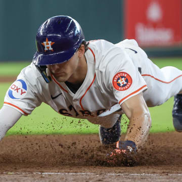 Jun 23, 2024; Houston, Texas, USA; Houston Astros right fielder Joey Loperfido dives back to first.