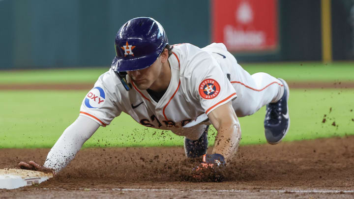 Jun 23, 2024; Houston, Texas, USA; Houston Astros right fielder Joey Loperfido dives back to first.