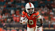 Nov 15, 2025; Miami Gardens, Florida, USA; Miami Hurricanes wide receiver Malachi Toney (10) carries the football for a touchdown against NC State Wolfpack during the fourth quarter at Hard Rock Stadium. Mandatory Credit: Sam Navarro-Imagn Images