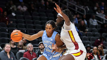 Oct 30, 2025; Atlanta, GA, USA; North Carolina Tar Heels guard Indya Nivar (24) dribbles the ball toward the basket against South Carolina Gamecocks center Madina Okot (11) during the first quarter at State Farm Arena. Mandatory Credit: Jordan Godfree-Imagn Images