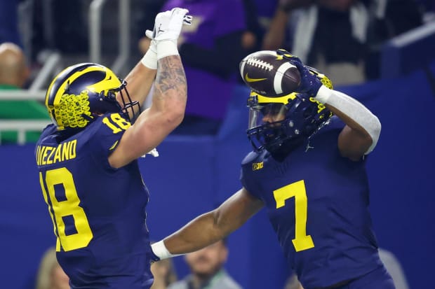 Michigan football's Donovan Edwards, Colston Loveland celebrate a touchdown in the national championship game vs. Washington