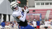 Bills wide receiver Keon Coleman pulls in a pass close to the sideline.