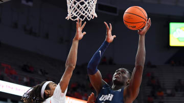 Nov 6, 2023; Syracuse, New York, USA; New Hampshire Wildcats forward Clarence Daniels (21) shoots against Syracuse. 