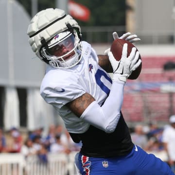 Bills wide receiver Keon Coleman pulls in a pass close to the sideline.