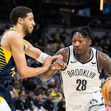 Apr 1, 2024; Indianapolis, Indiana, USA; Brooklyn Nets forward Dorian Finney-Smith (28) dribbles the ball while Indiana Pacers guard Tyrese Haliburton (0) defends in the second half at Gainbridge Fieldhouse. Mandatory Credit: Trevor Ruszkowski-Imagn Images