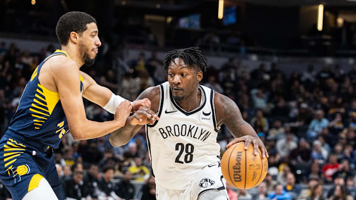 Apr 1, 2024; Indianapolis, Indiana, USA; Brooklyn Nets forward Dorian Finney-Smith (28) dribbles the ball while Indiana Pacers guard Tyrese Haliburton (0) defends in the second half at Gainbridge Fieldhouse. Mandatory Credit: Trevor Ruszkowski-Imagn Images