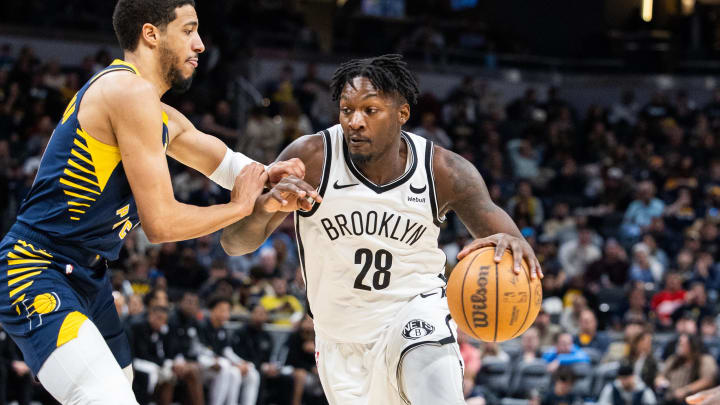 Apr 1, 2024; Indianapolis, Indiana, USA; Brooklyn Nets forward Dorian Finney-Smith (28) dribbles the ball while Indiana Pacers guard Tyrese Haliburton (0) defends in the second half at Gainbridge Fieldhouse. Mandatory Credit: Trevor Ruszkowski-USA TODAY Sports