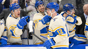 Feb 8, 2025; St. Louis, Missouri, USA;  St. Louis Blues center Radek Faksa (12) is congratulated by center Zack Bolduc (76) and center Jordan Kyrou (25) after scoring the game winning goal in the 10th round of shootouts against the Chicago Blackhawks at Enterprise Center. Mandatory Credit: Jeff Curry-Imagn Images