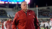 Arkansas' head coach Sam Pittman walks down the sideline assisted by a cane as both teams warm up before the AutoZone Liberty Bowl kicks off between Arkansas and Texas Tech in Memphis, Tenn., on Friday, December 27, 2024.