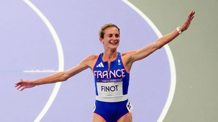 Aug 6, 2024; Paris Saint-Denis, France; Alice Finot (FRA) celebrates after placing fourth in the 3000m steeple chase during the Paris 2024 Olympic Summer Games at Stade de France. 