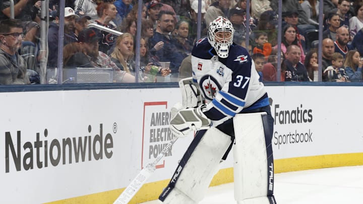 Apr 4, 2026; Columbus, Ohio, USA; Winnipeg Jets goalie Connor Hellebuyck (37) plays the puck on a Columbus Blue Jackets dump in during the second period at Nationwide Arena. Mandatory Credit: Russell LaBounty-Imagn Images