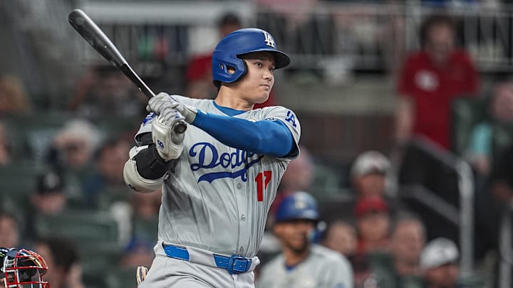 Sep 15, 2024; Cumberland, Georgia, USA; Los Angeles Dodgers designated hitter Shohei Ohtani (17) doubles to drive in a run against the Atlanta Braves during the fifth inning at Truist Park. Mandatory Credit: Dale Zanine-Imagn Images