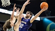 The Huskies' Wilhelm Breidenbach shoots over Oregon center Nate Bittle.