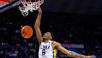 Feb 22, 2025; Baton Rouge, Louisiana, USA; LSU Tigers forward Robert Miller III (6) dunks the ball against Florida Gators guard Alijah Martin (15) during the first half at Pete Maravich Assembly Center. Mandatory Credit: Stephen Lew-Imagn Images