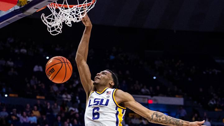 Feb 22, 2025; Baton Rouge, Louisiana, USA; LSU Tigers forward Robert Miller III (6) dunks the ball against Florida Gators guard Alijah Martin (15) during the first half at Pete Maravich Assembly Center. Mandatory Credit: Stephen Lew-Imagn Images