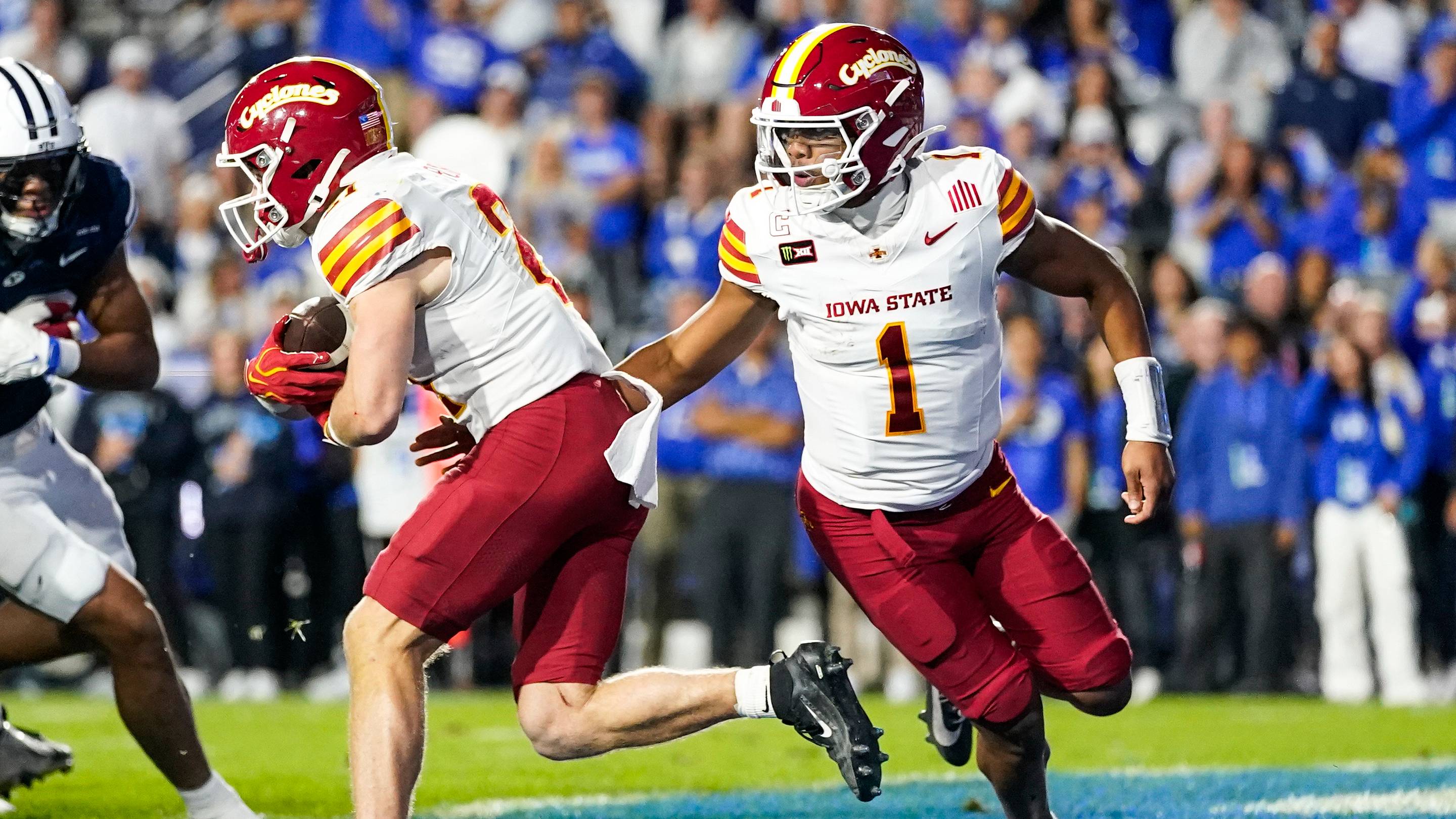 Oct 9, 2026; Provo, Utah, USA; Iowa State Cyclones quarterback Jaylen Raynor (1) Hans the ball off to running back Aiden Flora (21) during the second half at LaVell Edwards Stadium. Mandatory Credit: Aaron Baker-Imagn Images | IMAGN IMAGES via Reuters Connect