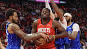 Nov 3, 2025; Houston, Texas, USA;Dallas Mavericks forward P.J. Washington (25) and Houston Rockets center Clint Capela (30) fight over a rebound in the second quarter at Toyota Center. Mandatory Credit: Thomas Shea-Imagn Images