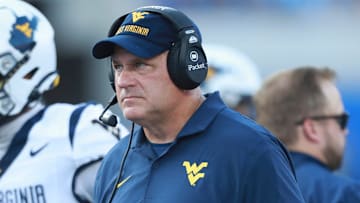 West Virginia Mountaineers head coach Rich Rodriguez looks at plays during the first half of the game against Kansas Jayhawks at David Booth Kansas Memorial Stadium on Sept. 20, 2025.