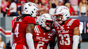 Aug 28, 2025; Raleigh, North Carolina, USA; North Carolina State Wolfpack safety Ronnie Royal III (2),  linebacker Tra Thomas (4) and  linebacker Kenny Soares Jr. (33) celebrate during the first half of the game against East Carolina Pirates at Carter-Finley Stadium. Mandatory Credit: Jaylynn Nash-Imagn Images