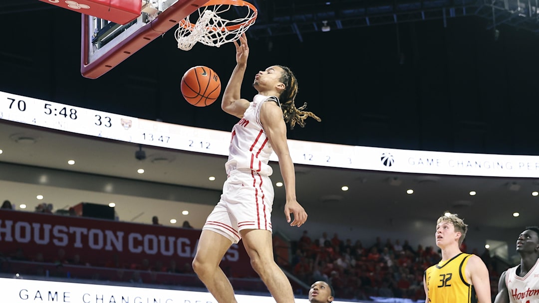 Nov 12, 2025; Houston, Texas, USA; Houston Cougars guard Kingston Flemings (4) dunks the ball during the second half against the Oakland Golden Grizzlies at Fertitta Center. Mandatory Credit: Troy Taormina-Imagn Images