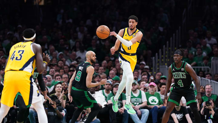 May 23, 2024; Boston, Massachusetts, USA; Indiana Pacers guard Tyrese Haliburton (0) passes the ball against Boston Celtics guard Derrick White (9) in the first half during game two of the eastern conference finals for the 2024 NBA playoffs at TD Garden. Mandatory Credit: David Butler II-USA TODAY Sports