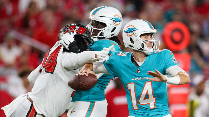 Miami Dolphins quarterback Mike White (14) gets pressured on a fourth-down play in the second quarter during preseason at Raymond James Stadium.