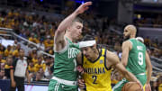 May 27, 2024; Indianapolis, Indiana, USA; Indiana Pacers guard Andrew Nembhard (2) drives to the basket while Boston Celtics guard Payton Pritchard (11) blocks during the first quarter during game four of the eastern conference finals for the 2024 NBA playoffs at Gainbridge Fieldhouse.