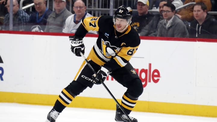 Feb 6, 2024; Pittsburgh, Pennsylvania, USA;  Pittsburgh Penguins center Sidney Crosby (87) skates with the puck against the Winnipeg Jets during the second period at PPG Paints Arena. Mandatory Credit: Charles LeClaire-USA TODAY Sports