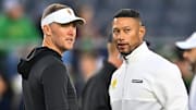 Oct 14, 2023; South Bend, Indiana, USA; USC Trojans head coach Lincoln Riley and Notre Dame Fighting Irish head coach Marcus Freeman chat before the game at Notre Dame Stadium. 