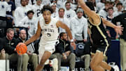 Dec 5, 2024; University Park, Pennsylvania, USA; Penn State Nittany Lions guard/forward Puff Johnson (5) dribbles the ball as Purdue Boilermakers forward Trey Kaufman-Renn (4) defends during the first half at Bryce Jordan Center. Penn State defeated Purdue 81-70. Mandatory Credit: Matthew O'Haren-Imagn Images
