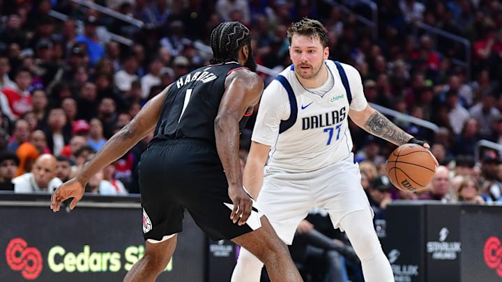 Nov 25, 2023; Los Angeles, California, USA; Dallas Mavericks guard Luka Doncic (77) controls the ball against Los Angeles Clippers guard James Harden (1) during the second half Crypto.com Arena. Mandatory Credit: Gary A. Vasquez-Imagn Images