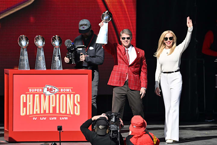 Kansas City Chiefs chairman and co-owner Clark Hunt holds the Vince Lombardi Trophy on stage with his wife Tavia.