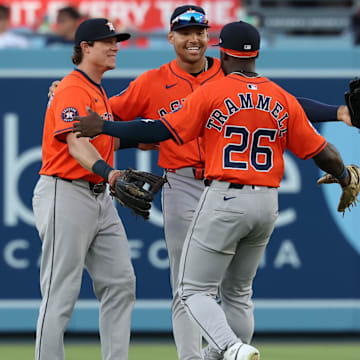 Jul 5, 2025; Los Angeles, California, USA;  (From left to right) Houston Astros center fielder Jake Meyers (6) and right fielder Cam Smith (11) and left fielder Taylor Trammell (26) celebrate a win after defeating the Los Angeles Dodgers 6-4 at Dodger Stadium.