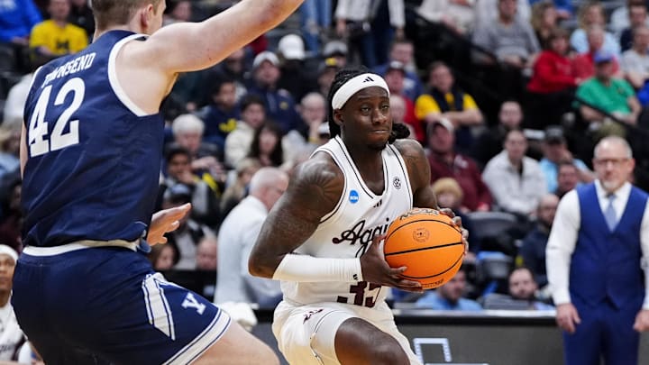 March 20, 2025; Denver, CO, USA; Texas A&M Aggies guard Manny Obaseki (35) drives against Yale Bulldogs forward Nick Townsend (42) during the second half at Ball Arena. Mandatory Credit: Ron Chenoy-Imagn Images
