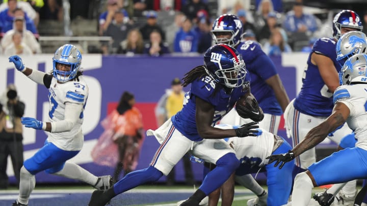 Aug 8, 2024; East Rutherford, New Jersey, USA;  New York Giants running back Dante Miller (25) runs the ball during the game against the Detroit Lions at MetLife Stadium.  