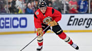 Dec 30, 2024; Chicago, Illinois, USA; Chicago Blackhawks center Connor Bedard (98) skates with the puck during a practice session prior to the Winter Classic ice hockey game against the St. Louis Blues at Wrigley Field. Mandatory Credit: Daniel Bartel-Imagn Images
