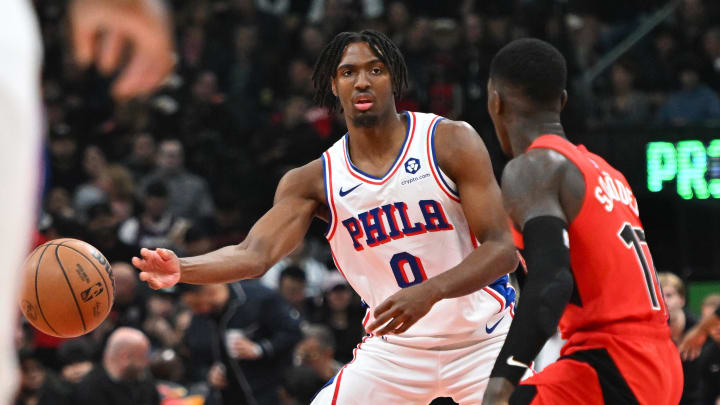 Oct 28, 2023; Toronto, Ontario, CAN;   Philadelphia 76ers guard Tyrese Maxey (0) passes the ball away from Toronto Raptors guard Dennis Schroder (17) in the first half at Scotiabank Arena. Mandatory Credit: Dan Hamilton-USA TODAY Sports