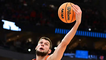 Mar 23, 2025; Milwaukee, WI, USA;  Illinois Fighting Illini center Tomislav Ivisic (13) drives to the basket against Kentucky Wildcats guard Koby Brea (4) during the first half in the second round of the NCAA Tournament at Fiserv Forum. Mandatory Credit: Benny Sieu-Imagn Images