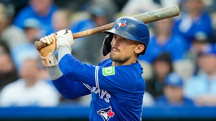 Apr 22, 2024; Kansas City, Missouri, USA; Toronto Blue Jays second base Cavan Biggio (8) hits a double during the third inning against the Kansas City Royals at Kauffman Stadium. Mandatory Credit: Jay Biggerstaff-USA TODAY Sports