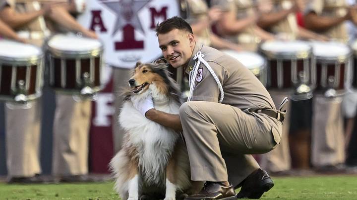 Oct 11, 2025; College Station, Texas, USA; Cadet Wilson Winchester takes a knee with Texas A&M Aggies mascot Reveille X prior to the game against the Florida Gators at Kyle Field. Mandatory Credit: Maria Lysaker-Imagn Images 