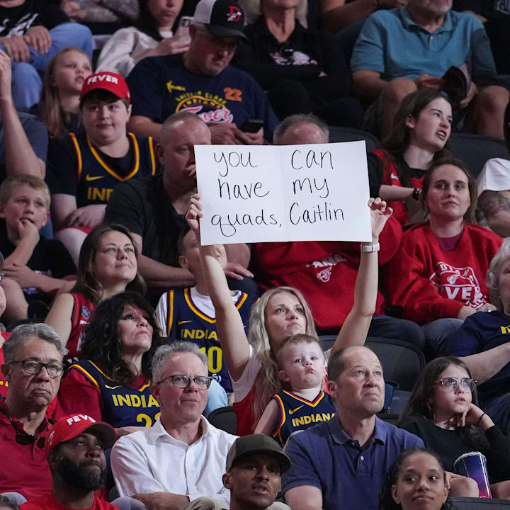 An Indiana Fever holds up a sign for Indiana Fever guard Caitlin Clark during a game against the Connecticut Sun. 