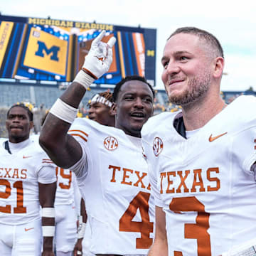 Texas quarterback Quinn Ewers (3) and teammates celebrate 31-12 win over Michigan at Michigan Stadium in Ann Arbor on Saturday, September 7, 2024.