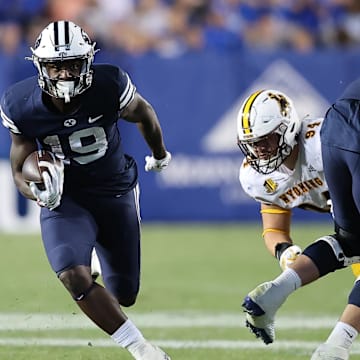 Sep 24, 2022; Provo, Utah, USA; Brigham Young Cougars running back Miles Davis (19) runs the ball in the fourth quarter against the Wyoming Cowboys at LaVell Edwards Stadium.