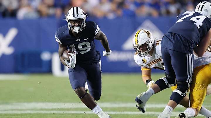 Sep 24, 2022; Provo, Utah, USA; Brigham Young Cougars running back Miles Davis (19) runs the ball in the fourth quarter against the Wyoming Cowboys at LaVell Edwards Stadium.