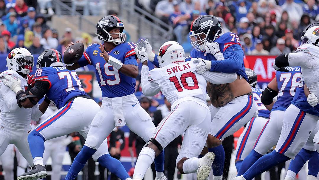 Oct 4, 2026; East Rutherford, New Jersey, USA; New York Giants quarterback Jameis Winston (19) looks to pass under pressure from Arizona Cardinals linebacker Josh Sweat (10) during the second quarter at MetLife Stadium. Mandatory Credit: Brad Penner-Imagn Images