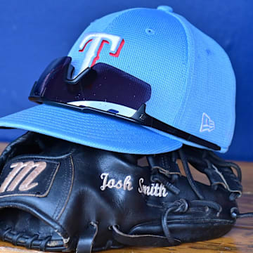 Mar 15, 2024; Salt River Pima-Maricopa, Arizona, USA; General view of a Texas Rangers hat, glove, and glasses prior to a spring training game against the Colorado Rockies at Salt River Fields at Talking Stick. 